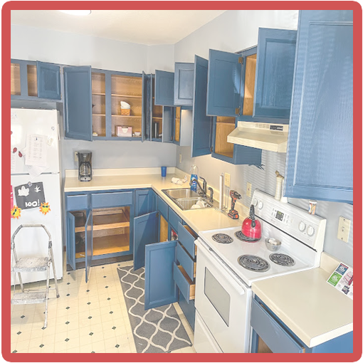 Blue cabinets showcasing The Painting Doctor's professional painting services in Sterling, IL, adding a contemporary flair to kitchen interiors.