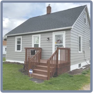 Grey exterior house painted by The Painting Doctor, highlighting quality exterior painting services in Sterling, IL.