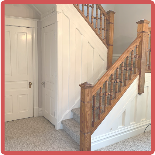 White staircase with stained railing trim, highlighting The Painting Doctor's expertise in detailed interior painting in Sterling, IL.