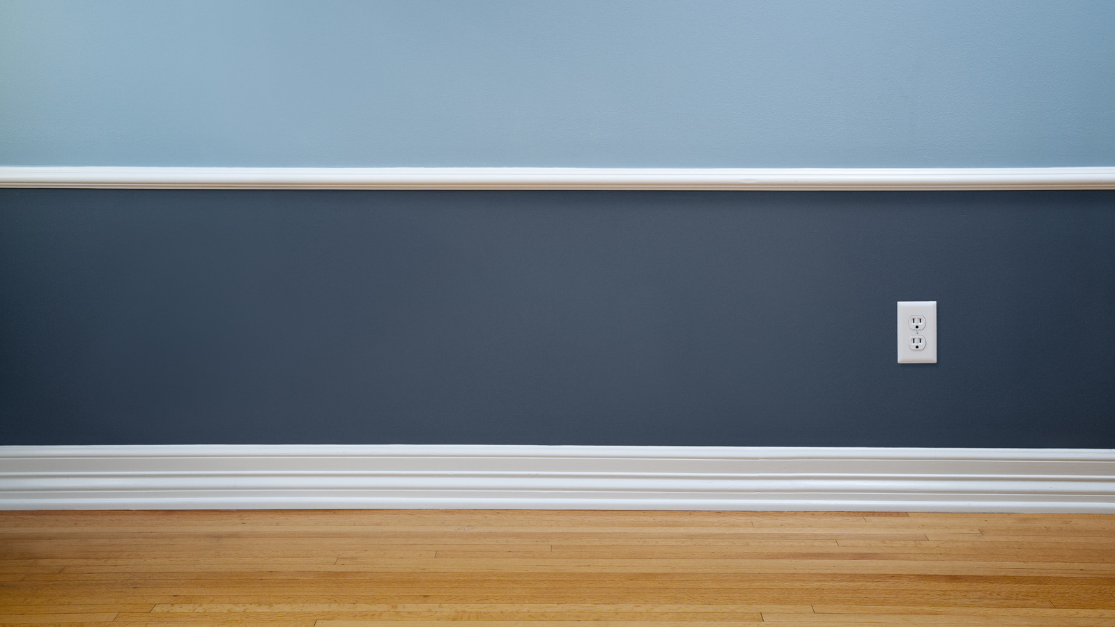 Empty room with blue walls and white trim, highlighting The Painting Doctor's expertise in interior painting in Sterling, IL.